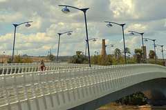 Woman crossing the footbridge to la Cartuja